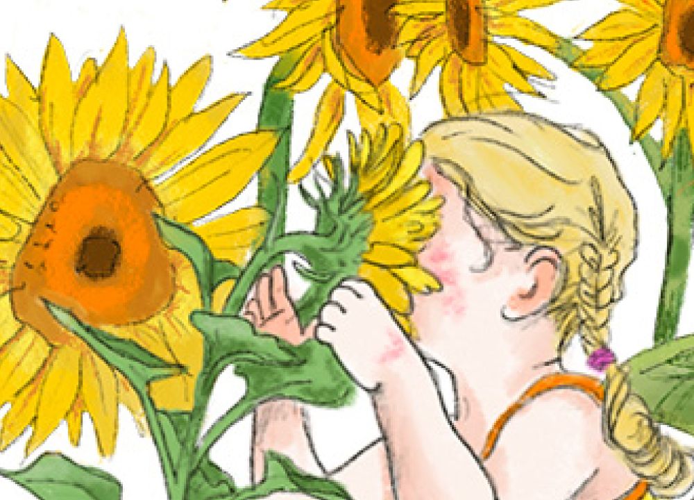 Mädchen im gelben Kleid riecht an Sonnenblumen
